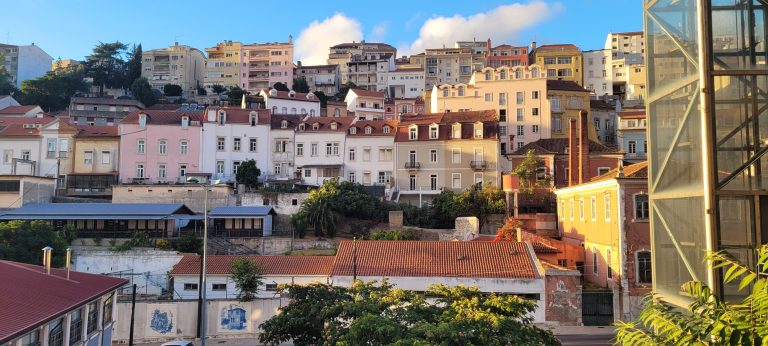 Stunning view of the buildings on hills in the Baixa area of Coimbra. Building beautifully backlit by sunlight.
